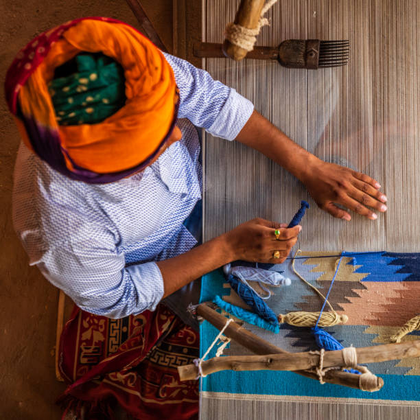 istock Indian man weaving textiles (durry) in Rajasthan 1436740186