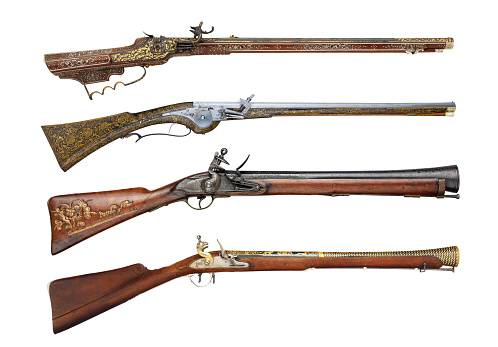 Old ancient 17th and 18th century rifle firearms isolated on white background. Real antique wheellock and flintlock guns side view