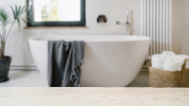 istock Wooden shelf for cosmetics products against blurred bathroom interior 1436741032