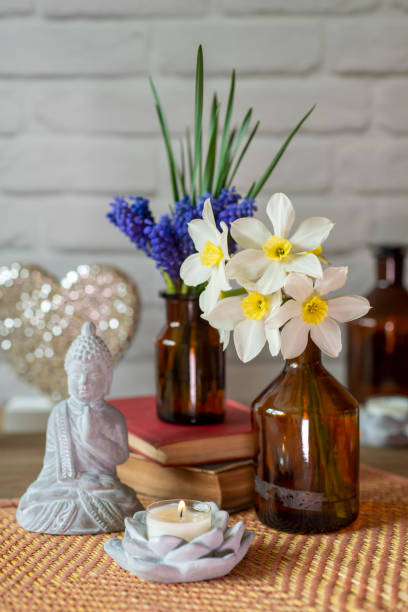 istock Grape Hyacinth bouquet with spring flowers, book, buddha and candle 1436741599