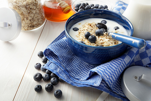 Breakfast with belgian waffles, muesli, fresh fruits on white background. Flat lay, top view