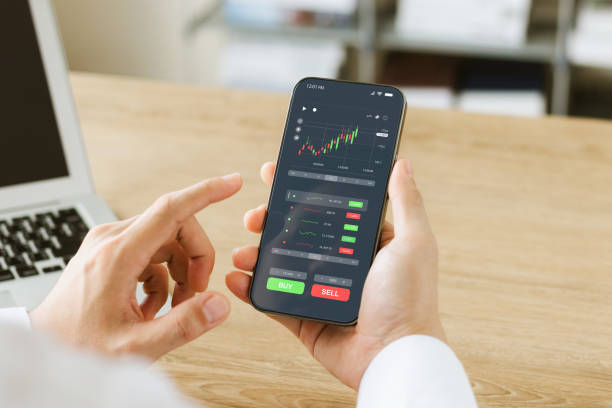 Businessmen work with stock market investments using smartphones to analyze trading data. smartphone with stock exchange graph on screen. Financial stock market. stock photo