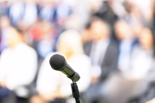 istock Business conference event, corporate presentation or training, microphone in the focus, blurred audience in the background 1436750051