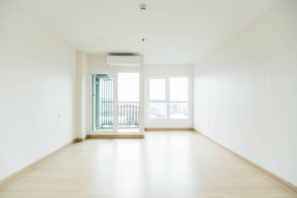 istock Empty room is decorated with an engineering wooden floor and wallpaper on the wall with sunlight from the window. Minimalist interior design and real estate for decoration. Real image with copy space. 1436753461