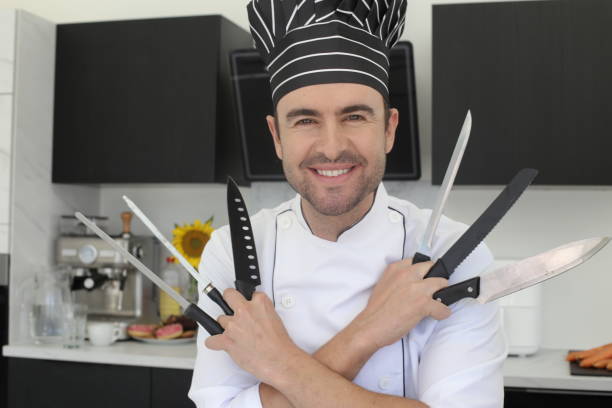 Chef holding a bunch of knives