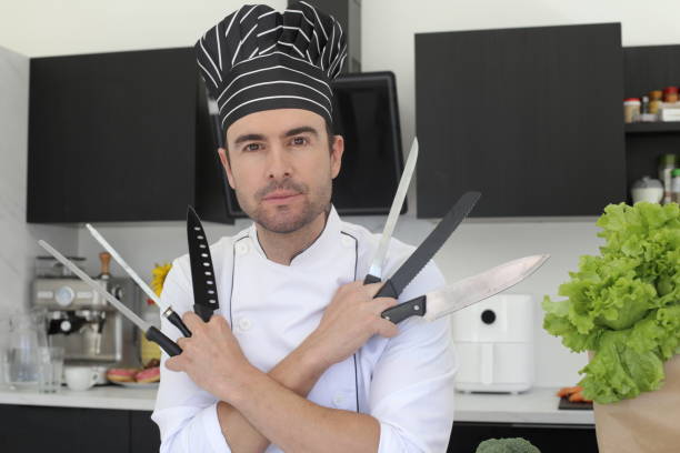 istock Chef holding a bunch of knives 1436754036