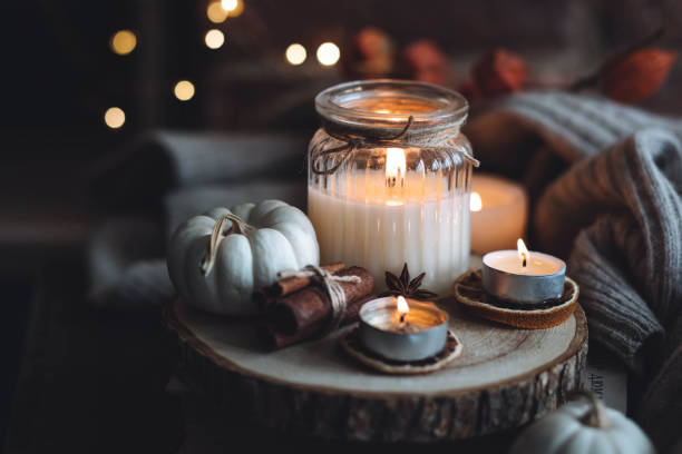 istock Autumn home composition with aromatic candle, dry citrus, cinnamon, anise. Aromatherapy on a grey fall morning, atmosphere of cosiness and relax. Wooden background close up 1436756889