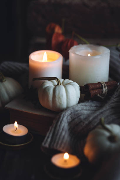 istock Autumn home composition with aromatic candle, dry citrus, cinnamon, anise. Aromatherapy on a grey fall morning, atmosphere of cosiness and relax. Wooden background close up 1436756892