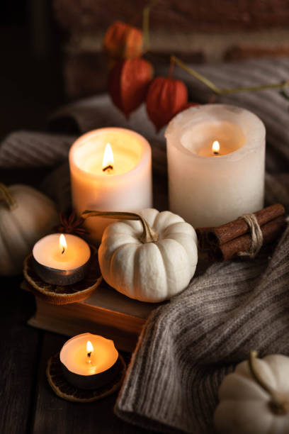 istock Autumn home composition with aromatic candle, dry citrus, cinnamon, anise. Aromatherapy on a grey fall morning, atmosphere of cosiness and relax. Wooden background close up 1436756896