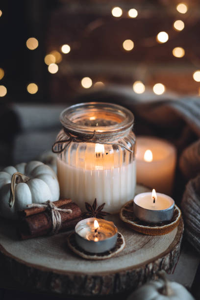 istock Autumn home composition with aromatic candle, dry citrus, cinnamon, anise. Aromatherapy on a grey fall morning, atmosphere of cosiness and relax. Wooden background close up 1436756902