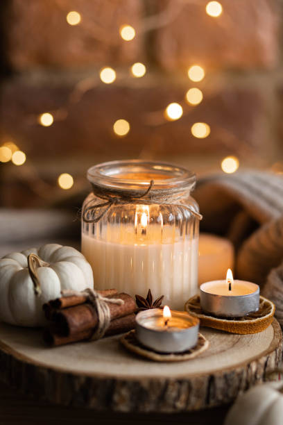 istock Autumn home composition with aromatic candle, dry citrus, cinnamon, anise. Aromatherapy on a grey fall morning, atmosphere of cosiness and relax. Wooden background close up 1436756917