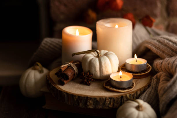 istock Autumn home composition with aromatic candle, dry citrus, cinnamon, anise. Aromatherapy on a grey fall morning, atmosphere of cosiness and relax. Wooden background close up 1436756919