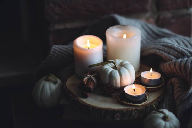istock Autumn home composition with aromatic candle, dry citrus, cinnamon, anise. Aromatherapy on a grey fall morning, atmosphere of cosiness and relax. Wooden background close up 1436756920