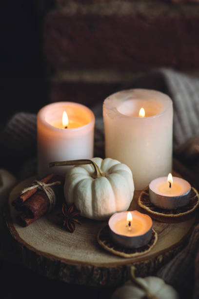 istock Autumn home composition with aromatic candle, dry citrus, cinnamon, anise. Aromatherapy on a grey fall morning, atmosphere of cosiness and relax. Wooden background close up 1436756925