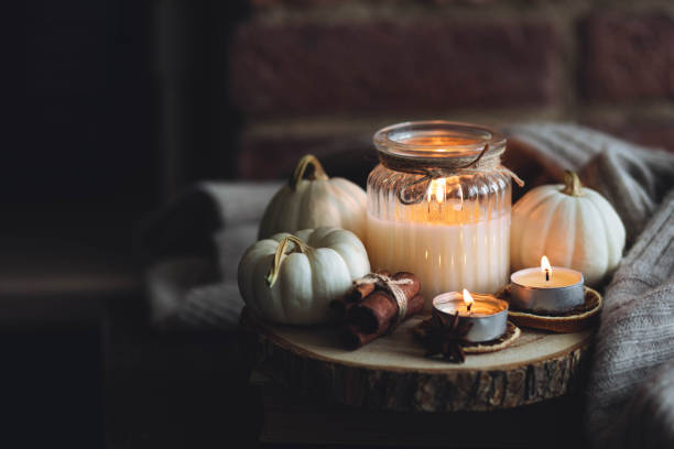 istock Autumn home composition with aromatic candle, dry citrus, cinnamon, anise. Aromatherapy on a grey fall morning, atmosphere of cosiness and relax. Wooden background close up 1436757094