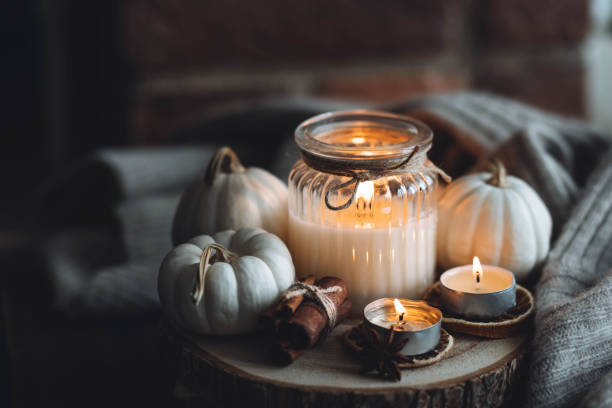 istock Autumn home composition with aromatic candle, dry citrus, cinnamon, anise. Aromatherapy on a grey fall morning, atmosphere of cosiness and relax. Wooden background close up 1436757097