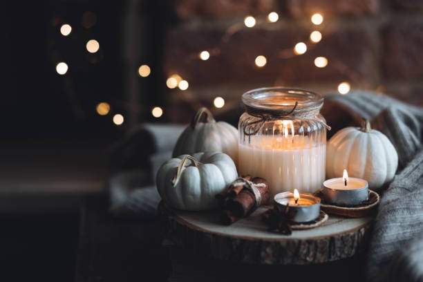 istock Autumn home composition with aromatic candle, dry citrus, cinnamon, anise. Aromatherapy on a grey fall morning, atmosphere of cosiness and relax. Wooden background close up 1436757106
