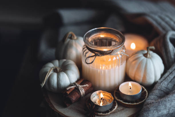 istock Autumn home composition with aromatic candle, dry citrus, cinnamon, anise. Aromatherapy on a grey fall morning, atmosphere of cosiness and relax. Wooden background close up 1436757107