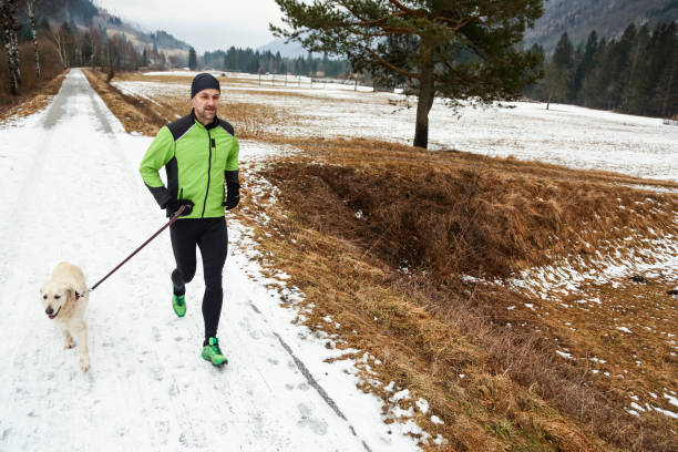 istock Running with dog in winter 1436758863