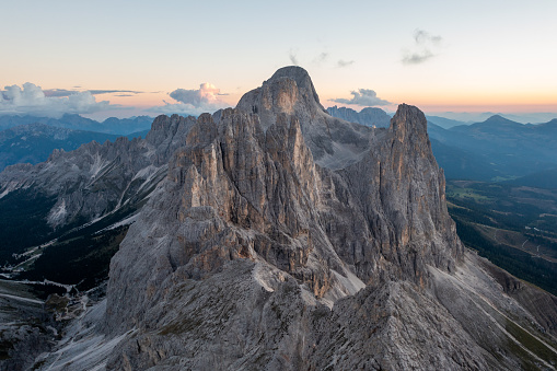 The Vajolet towers are six summits in the Dolomites in Val di Fassa, Italy. The sun is setting, creating some wonderful colours in the horizon. This alpine scene provides stunning views of the mountain range.