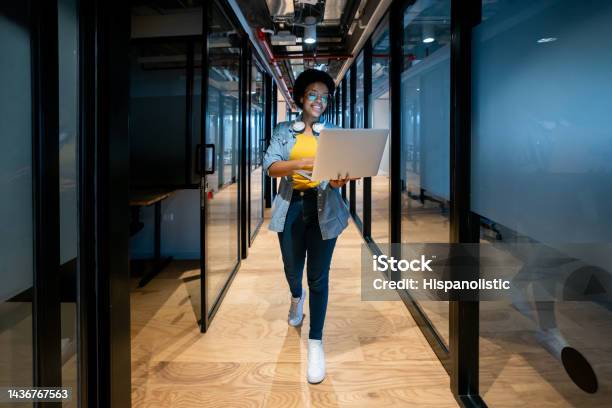 Happy It Technician Working At The Office Using Her Laptop Stock Photo - Download Image Now