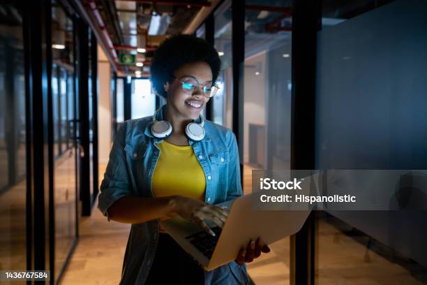It Technician Working Late At The Office Using Her Laptop Stock Photo - Download Image Now