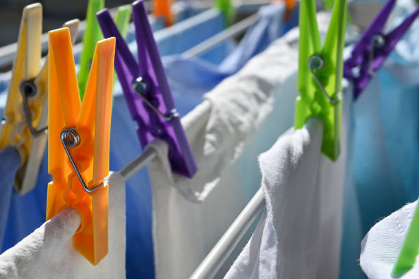 istock colorful plastic clothes pegs on rack 1436770606