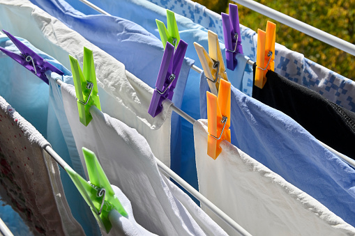 clothes rack with towels and bedlinen drying on a sunny day