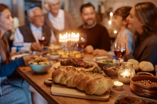 istock Traditional Challah bread at dining table during family dinner on Hanukkah. 1436771402