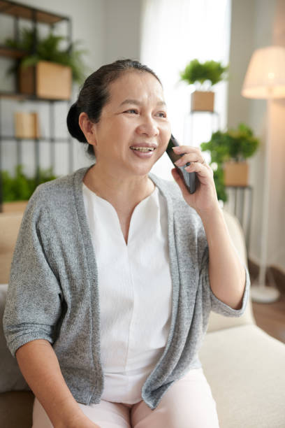 istock Positive Elderly Woman Calling on Phone 1436774328