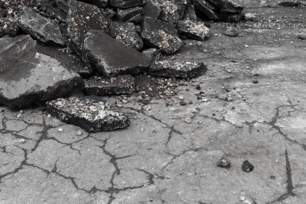 istock Old asphalt road is under reconstruction, grungy broken asphalt 1436774749