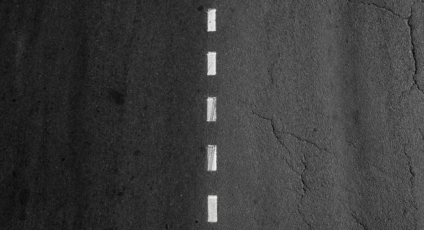 istock Dotted dividing road marking line goes over asphalt highway 1436774761