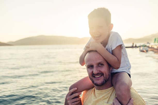 Shot of a young man spending time at the beach with his son.