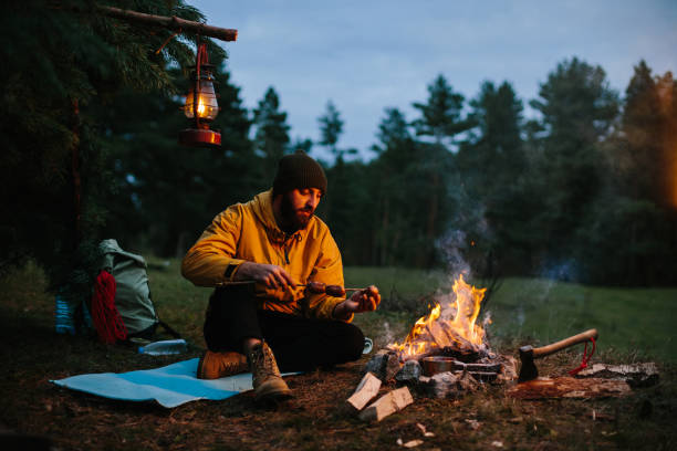 istock A lonely wanderer is having dinner in the mountains by a campfire. 1436777034