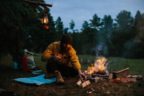 istock A lonely wanderer is having dinner in the mountains by a campfire. 1436777044