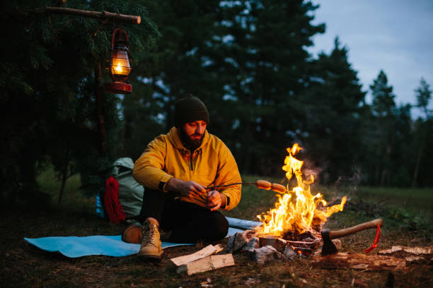 istock A lonely wanderer is having dinner in the mountains by a campfire. 1436777094