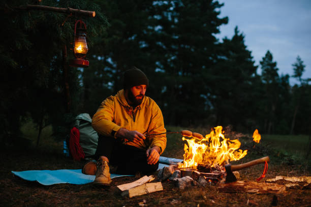 istock A lonely wanderer is having dinner in the mountains by a campfire. 1436777095