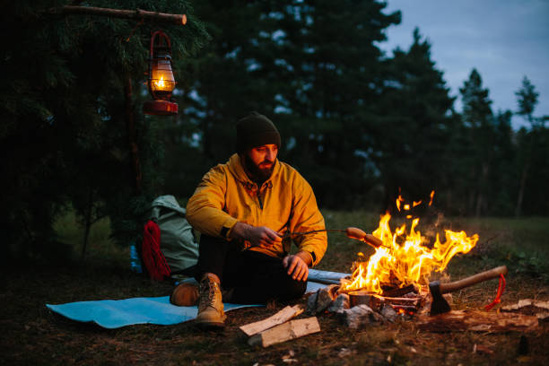 istock A lonely wanderer is having dinner in the mountains by a campfire. 1436777099