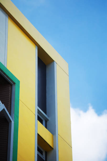 istock Corner of yellow condominium in blue sky 1436777548