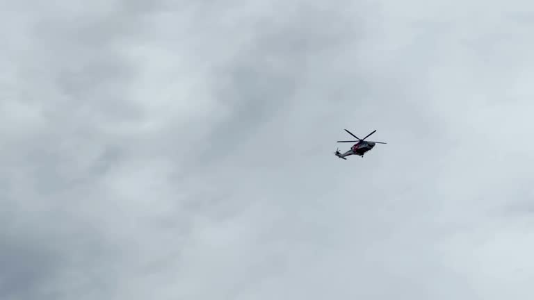 Helicopter flying over storm clouds