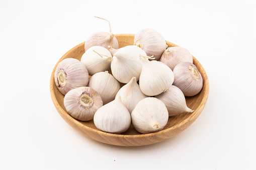 Raw white garlic with white background.