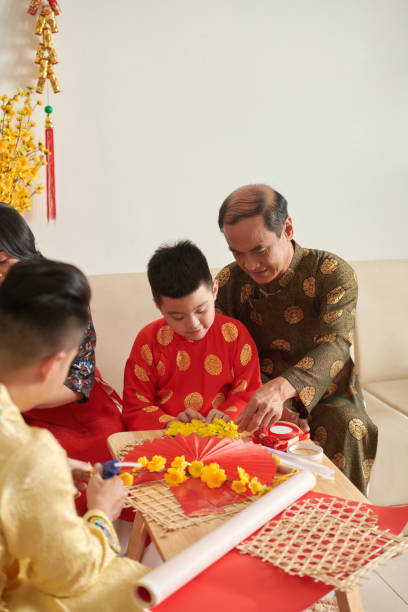 istock Family Making Tet decoration 1436778747