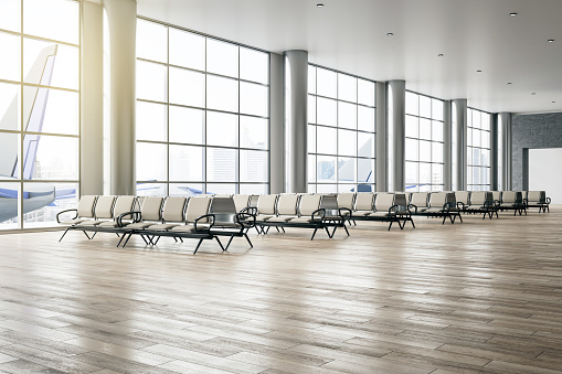 Business travel and avia concept with perspective view on light empty seat rows in sunlit spacious airport waiting area hall with huge panoramic windows and wooden floor. 3D rendering