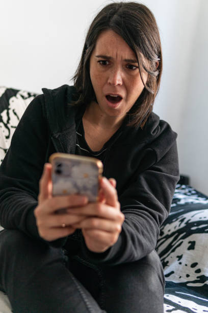 istock Surprised spanish woman watching her phone 1436780832