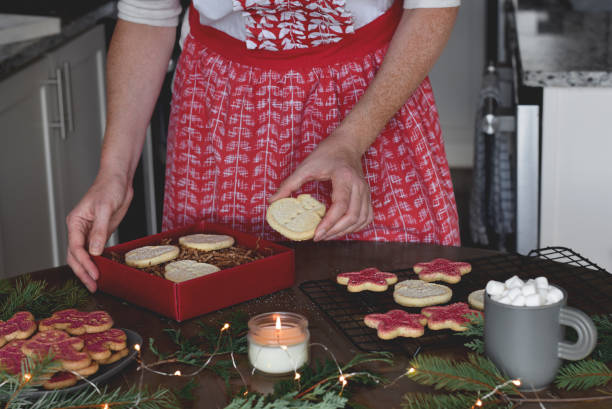istock Woman baking Christmas cookies for presents 1436780909
