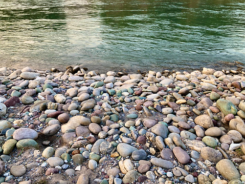 Multi colour stones near river water at bed level