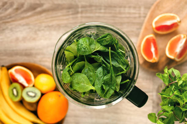 istock Fresh ripe spinach in blender on wooden table. Top view. 1436781351