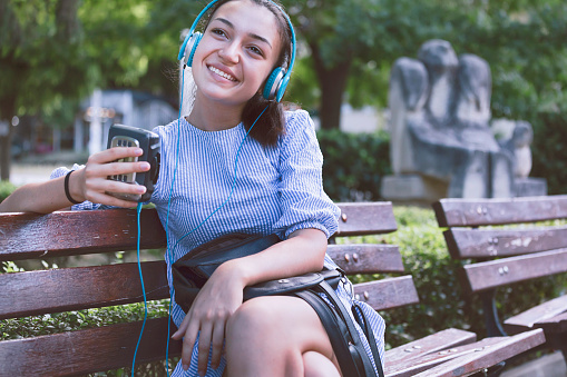 Happy girl with vintage cassette tape player. Retro style. Old school walkman. Listening music.