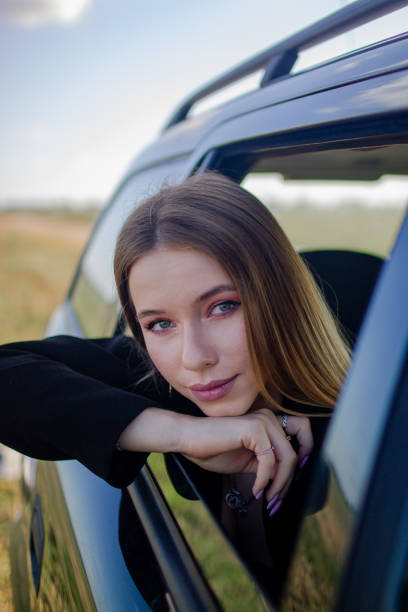 istock a girl rides in a car with an open window 1436782751