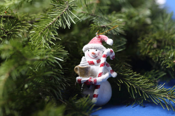 istock toy snowman on fur tree brunches. Winter concept 1436783168